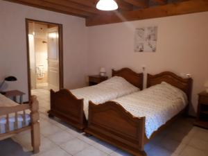 a bedroom with a wooden bed in a room at La Sénonaise in Sens sur Seille