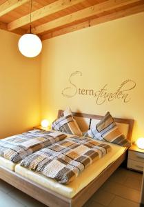 a bedroom with a bed with a sign on the wall at Weingut Markus Busch in Pünderich
