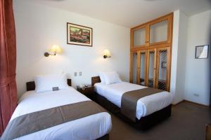 Postelja oz. postelje v sobi nastanitve DM Hoteles Cusco