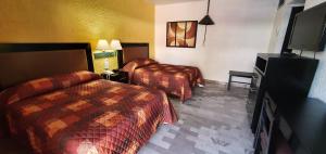 Cama o camas de una habitación en Hotel Azteca Inn