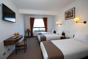 Postelja oz. postelje v sobi nastanitve DM Hoteles Cusco