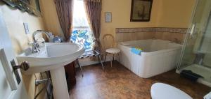a bathroom with a tub and a sink and a toilet at A Moment in Time Bed and Breakfast in Niagara Falls