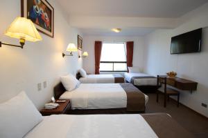 Postelja oz. postelje v sobi nastanitve DM Hoteles Cusco