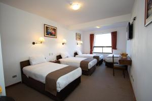 Postel nebo postele na pokoji v ubytování DM Hoteles Cusco