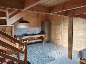 Una cocina con refrigerador de acero inoxidable en una habitación. en Newland Wójtowicz, en Debrznica