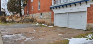 an empty parking lot next to a building with a garage at A Night to Remember B & B in Niagara Falls