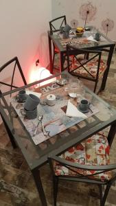 two tables with dishes and bowls on top at THAT'S AMORE FIUMICINO Airport in Fiumicino