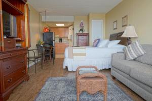 a bedroom with a bed and a living room with a couch at The Crossings Ocean City in Ocean City