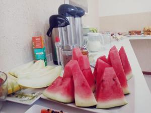 a bunch of slices of watermelon on a counter at Hotel Centenario Itajuba in Itajubá