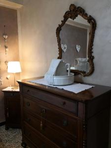 a dresser with a mirror on top of it at "Lemon Tree House" Relax&Bike in campagna a Finale Ligure con Air Cond in Orco Feglino