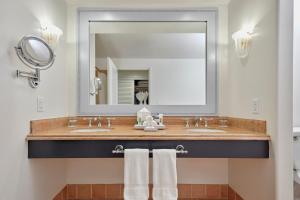 a bathroom with a sink and a mirror at Universal's Loews Portofino Bay Hotel in Orlando