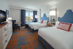 a hotel room with two beds and a television at Universal's Loews Portofino Bay Hotel in Orlando +37 photos