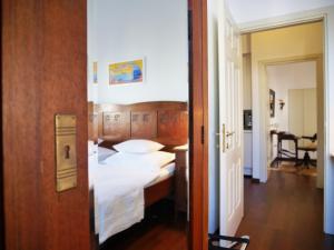 a hotel room with a bed with white sheets at Novak Bonaparte - Hvar city center in Hvar