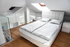 a bedroom with a white bed and a glass wall at MK Apartment 100m2 Friends&Family in Krakow