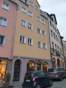a car is parked in front of a building at White Pearl Hostel 2 in Nuremberg