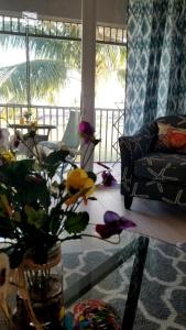 a living room with a vase of flowers on a table at GreenLinks Golf View Villa Mustang at Lely Resort in Naples