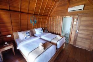 Postel nebo postele na pokoji v ubytování Adara Beach Huts