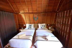 Postel nebo postele na pokoji v ubytování Adara Beach Huts