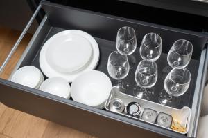 a set of wine glasses and plates in a drawer at marutto Ishikawa in Kanazawa