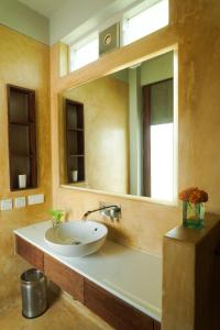 a bathroom with a sink and a mirror at Anaya's Lake House in Cochin