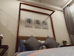 a bedroom with a large mirror above a bed at Desiran @ Timurbay - seafront studio apartment with WiFi in Kuantan