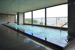 a large pool of water in a building with windows at Inasayama Kanko Hotel in Nagasaki