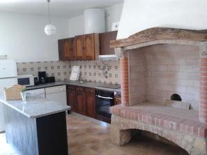uma cozinha com uma lareira de tijolos em Rc - Alcobaca Villa! em Alcobaça