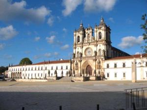 a large white building with a clock tower on it at Rc - Alcobaca Villa in Alcobaça