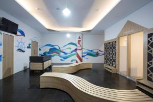 a room with a mural of a lighthouse on the wall at Kapal Garden Hotel at Rekreasi Sengkaling in Malang