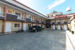 a car parked in front of a building at RedDoorz near Lapasan Plaza Cagayan de Oro in Cagayan de Oro