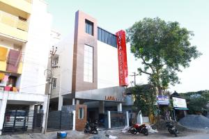 a building with motorcycles parked in front of it at Laya Regency in Mayiladuthurai