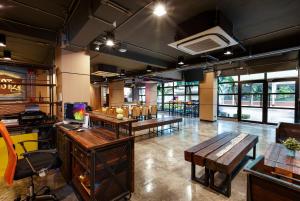 a room with desks and tables in a restaurant at Rest24 Residence in Bangkok