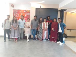 a group of people posing for a picture in a room at The Hotel Canoe in Kannur