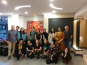 a group of people posing for a picture in a lobby at The Hotel Canoe in Kannur