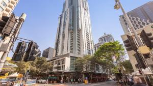 a city with tall buildings and a street with people at Oaks Brisbane Festival Suites in Brisbane