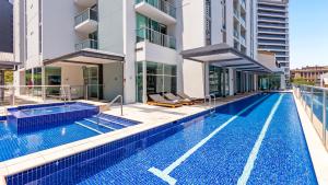 a large swimming pool in a large building at Oaks Brisbane Festival Suites in Brisbane