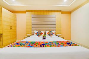 A bed or beds in a room at FabHotel Viraj Suites Gachibowli