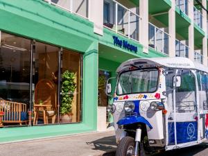 a small vehicle parked in front of a store at The Moana by DSH Resorts in Chatan