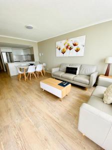 a living room filled with furniture and a couch at Kirra Beach Apartments in Gold Coast