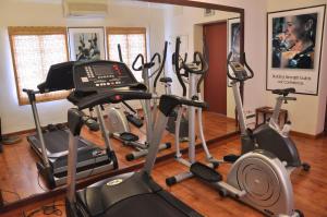 a gym with several treadmills and exercise bikes at Niketana @ Boat Club in Chennai
