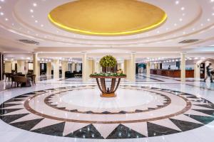 a lobby with a fountain in the middle of a building at Mitsis Grand Hotel in Rhodes Town