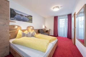 um quarto com uma cama grande com lençóis amarelos em Holiday Residence Mesenhaus em Maranza