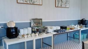 a room with two white tables with food on them at OB-Oon Resort in Aranyaprathet