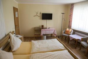 a living room with a couch and a table at Landhotel Weinrich in Naumburg