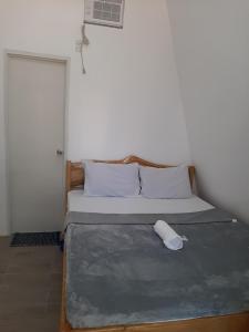a bedroom with a bed with a pillow on it at travis homestay in Siquijor