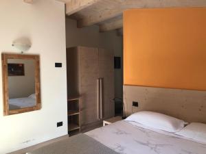 a bedroom with a bed and a mirror at Marzia Lounge in Bormio