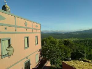 a view of a building with a view of a valley at Casa Amoreira - Quinta Amoreira in Faro