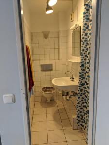 a bathroom with a sink and a toilet at Ruhrtropolis Hostel in Essen