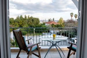 a view of a balcony with a table and chairs at Paleo Kalamaki in Isthmia