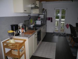 a kitchen with a sink and a stove top oven at Ferienwohnung im Neubauernweg 3 in Hoppegarten